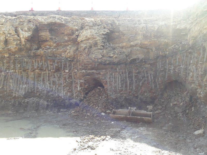 Excavation site showing exposed rock layers
